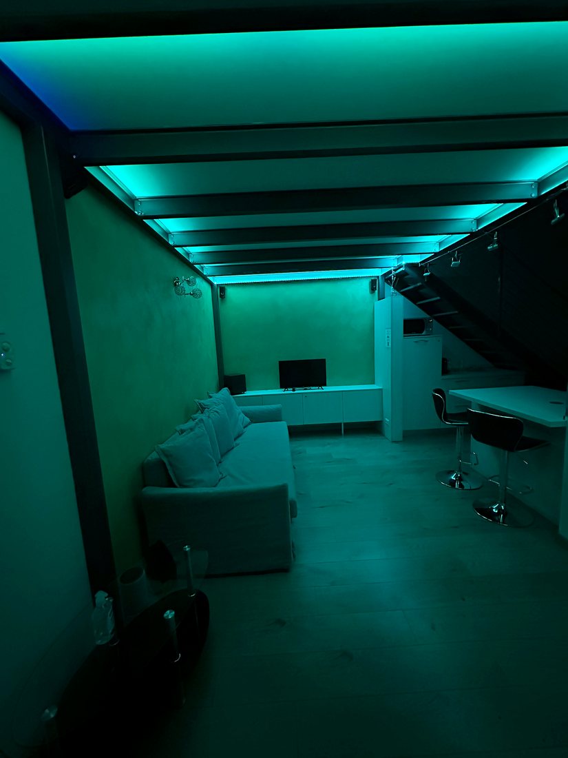 Il loft illuminato di verde acqua dalle luci LED a soffitto